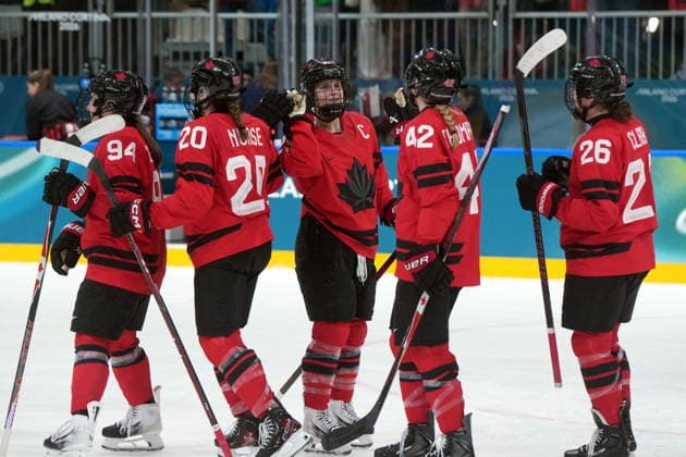 February 14, 2026, Milan, ITALY: Canada players skate past to high five teammate Marie-Philip Poulin (29) as they celebrate the team s 5-1 win over Germany following the third period of a women s hockey quarterfinal game at the 2026 Winter Olympics, in Milan, Saturday, Feb. 14, 2026. Canada News - February 14, 2026  - ZUMAc35_ 20260214_zaf_c35_081 Copyright: xDarrylxDyckx
