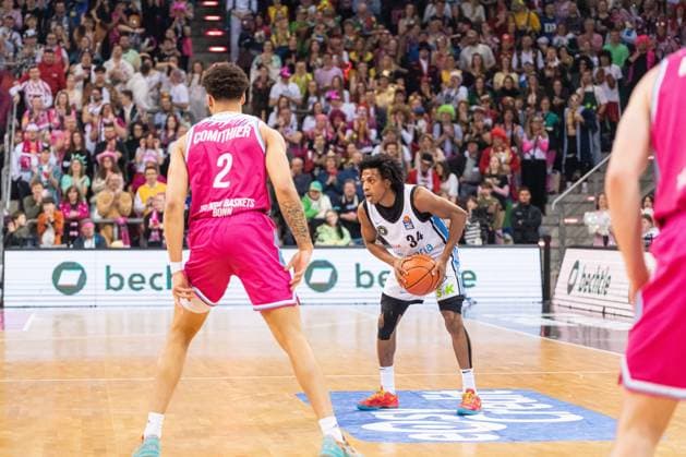 Spielaktion mit Alijah Comithier (2; Telekom Baskets Bonn) und Ross Williams (34; Veolia Towers Hamburg) auf dem Spielfeld in der Partie zwischen Telekom Baskets Bonn und Veolia Towers Hamburg am 20. Spieltag in der EasyCredit BBL in Bonn beim Karnevalsspiel. Alijah Comithier (2; Telekom Baskets Bonn) gegen Ross Williams (34; Veolia Towers Hamburg) in Aktion