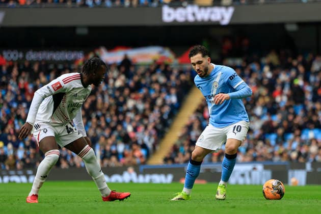 Manchester City v Salford City, FA Cup Rayan Cherki (10) of Manchester City controls the ball watched by Rosaire Longelo (45) of Salford City during the FA Cup match between Manchester City and Salford City at the Etihad Stadium, Manchester, UK on 14 February 2026. Manchester Etihad Stadium Manchester UK Editorial use only DataCo restrictions apply See www.football-dataco.com , Copyright: xConorxMolloyx PSI-23752-0102