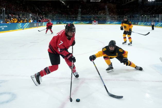 February 14, 2026, Milan, ITALY: Canada s Laura Stacey (7) and Germany s Ronja Hark vie for control of the puck during the third period of a women s hockey quarterfinal game at the 2026 Winter Olympics, in Milan, Saturday, Feb. 14, 2026. Canada News - February 14, 2026  - ZUMAc35_ 20260214_zaf_c35_084 Copyright: xDarrylxDyckx