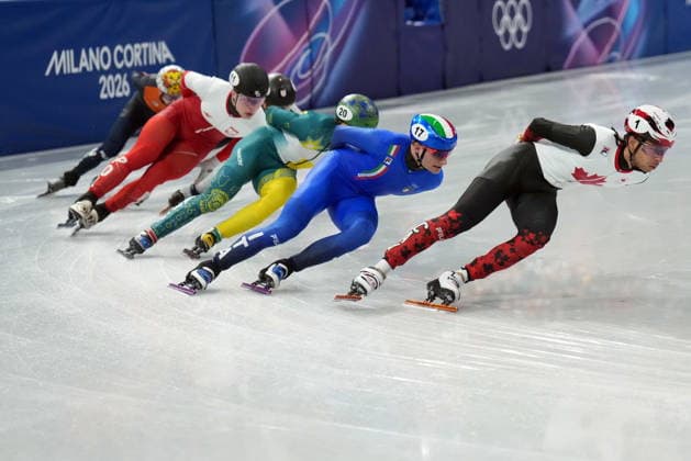 February 14, 2026, Milan, ITALY: Canada s William Dandjinou leads the pack while competing in the Men s quarterfinals 1500m Short Track Speed skating, Eisschnelllauf event during the 2026 Milan Cortina Winter Olympics in Milan, Italy on Saturday, February 14, 2026. Canada News - February 14, 2026  - ZUMAc35_ 20260214_zaf_c35_117 Copyright: xNathanxDenettex
