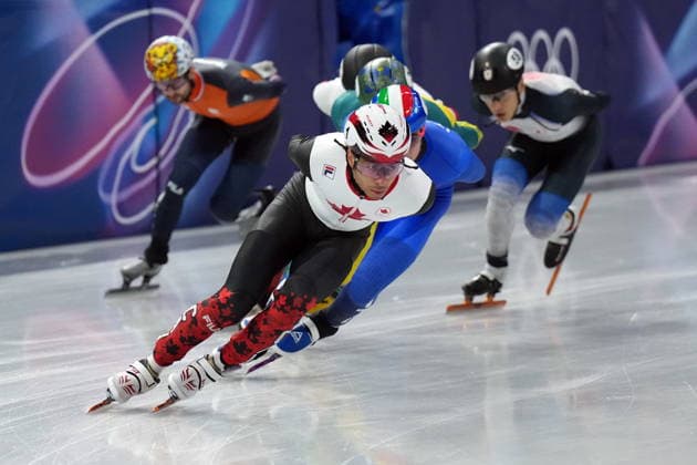 February 14, 2026, Milan, ITALY: Canada s William Dandjinou leads the pack while competing in the Men s quarterfinals 1500m Short Track Speed skating, Eisschnelllauf event during the 2026 Milan Cortina Winter Olympics in Milan, Italy on Saturday, February 14, 2026. Canada News - February 14, 2026  - ZUMAc35_ 20260214_zaf_c35_118 Copyright: xNathanxDenettex