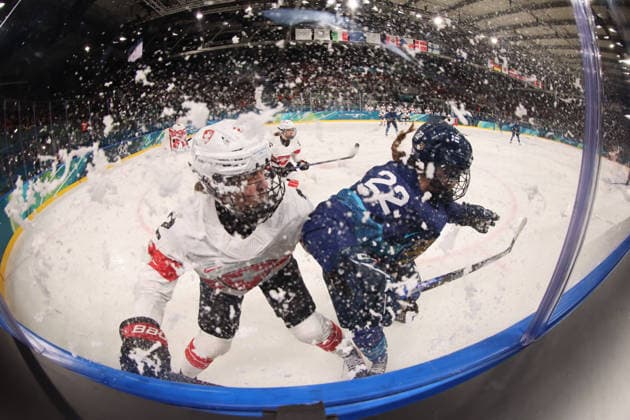 February 14, 2026, Milan, Lombardy, Italy: Julia Schalin 22 of Team Finland and Annic Buchi 2 of Team Switzerland in a women s Ice hockey, Eishockey quarterfinal during the Milano Cortina 2026 Olympic Winter games, Winterspiele,Spiele, Summer games at Milano Rho Ice Hockey Arena. Olympics 2026: Milano Cortina: Ice Hockey-Women Quarterfinal - FIN-SUI  - ZUMAm117 20260214_oly_m117_002 Copyright: xDavidxMcIntyrex