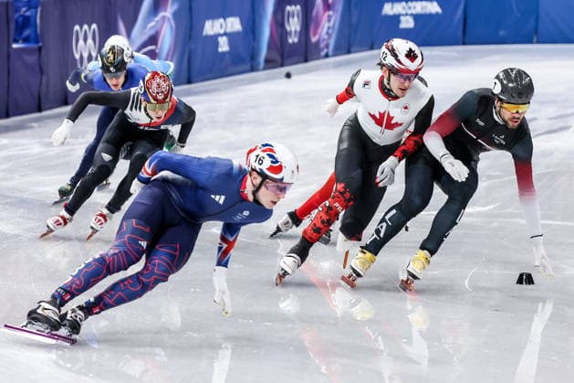 ITALY, MILAN - FEBRUARY 14, 2026: Niall Treacy of the UK, Felix Roussel of Canada and Roberts Kruzbergs (L-R front) of Latvia compete in the men s 1,500m short-track Speed skating, Eisschnelllauf semifinals during the 2026 Winter Olympic Games, Olympische Spiele, Olympia, OS at the Milano Ice Skating Arena. Peter Kovalev TASS  88719774