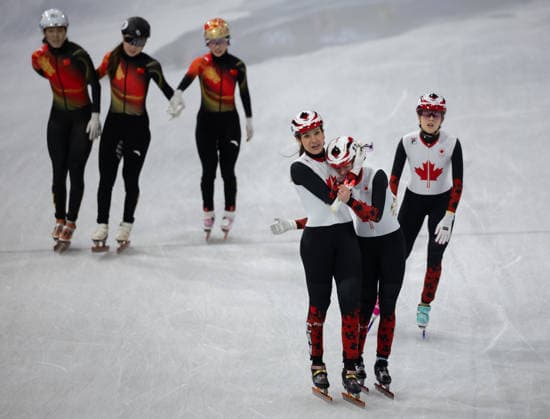 February 14, 2026, Milano, Lombardy, Italy: Courtney Sarault (14) of Canada and Kim Boutin (13) of Canada hugs after qualifying for the final in Short Track Speed skating, Eisschnelllauf Women 3000m relay during the semifinals during the 2026 Winter Olympics at the Milano Ice Skating Arena on Saturday in Milano. Olympics 2026: Milano Cortina: Short Track Speed Skating Women s  - ZUMAj89_ 20260214_oly_j89_036 Copyright: xPaulxKitagakixJr.x
