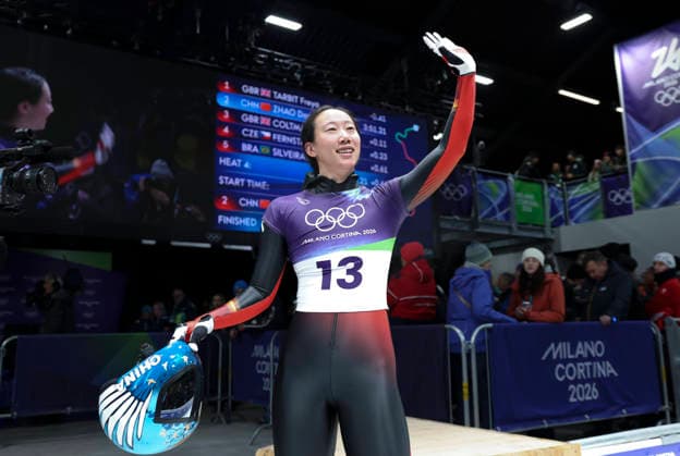 (260215) -- CORTINA D AMPEZZO, Feb. 15, 2026 -- Zhao Dan of China greets the audience during the skeleton women s heat at the Milan-Cortina 2026 Olympic Winter games, Winterspiele,Spiele, Summer games in Cortina, Italy, Feb. 14, 2026. ) (MICO2026)ITALY-CORTINA D AMPEZZO-OLYMPIC WINTER GAMES-SKELETON-WOMEN DingxXu 