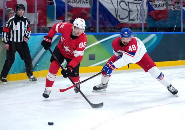(260215) -- MILAN, Feb. 15, 2026 -- Janis Moser (C) of Switzerland and Tomas Hertl (R) of the Czech Republic battle for the puck during the Ice hockey, Eishockey men s preliminary round group A match between Switzerland and the Czech Republic of the Milan-Cortina 2026 Olympic Winter games, Winterspiele,Spiele, Summer games in Milan, Italy, Feb. 15, 2026. ) (MICO2026)ITALY-MILAN-OLYMPIC WINTER GAMES-ICE HOCKEY-MEN-PRELIMINARY-SUI VS CZE TaoxXiyi 