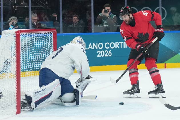 February 15, 2026, Milan, ITALY: Julian Junca (33) of Team France makes a save on Tom Wilson (43) of Team Canada during first period Olympic hockey action at the 2026 Milan Cortina Winter Olympics in Milan, Italy on Sunday Feb. 15, 2026. Canada News - February 15, 2026  - ZUMAc35_ 20260215_zaf_c35_066 Copyright: xNathanxDenettex