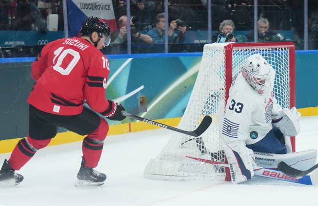February 15, 2026, Milan, ITALY: Julian Junca (33) of Team France makes on save on Nick Suzuki (10) of Team Canada during first period Olympic hockey action at the 2026 Milan Cortina Winter Olympics in Milan, Italy on Sunday Feb. 15, 2026. Canada News - February 15, 2026  - ZUMAc35_ 20260215_zaf_c35_070 Copyright: xNathanxDenettex