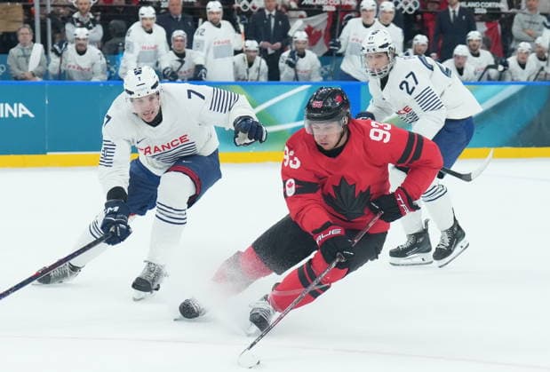 February 15, 2026, Milan, ITALY: Mitch Marner (93) of Team Canada controls the puck as Pierre Crinon (7) of Team France defends during first period Olympic hockey action at the 2026 Milan Cortina Winter Olympics in Milan, Italy on Sunday Feb. 15, 2026. Canada News - February 15, 2026  - ZUMAc35_ 20260215_zaf_c35_073 Copyright: xNathanxDenettex
