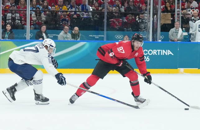 February 15, 2026, Milan, ITALY: Connor McDavid (97) of Team Canada controls the puck as Jules Boscq (27) of Team France defends during first period Olympic hockey action at the 2026 Milan Cortina Winter Olympics in Milan, Italy on Sunday Feb. 15, 2026. Canada News - February 15, 2026  - ZUMAc35_ 20260215_zaf_c35_074 Copyright: xNathanxDenettex