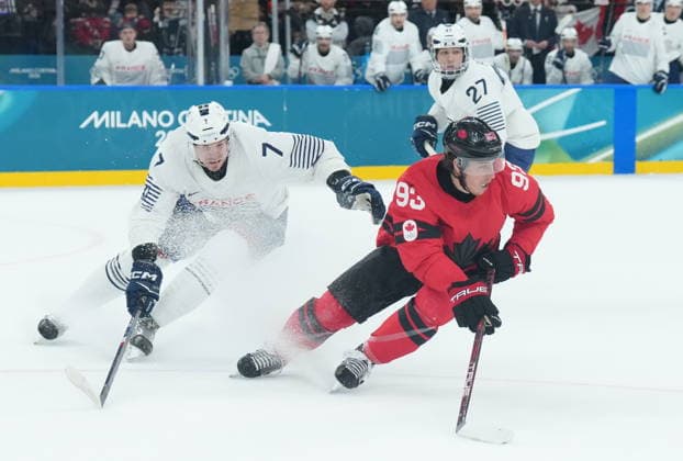 February 15, 2026, Milan, ITALY: Mitch Marner (93) of Team Canada controls the puck as Pierre Crinon (7) of Team France defends during first period Olympic hockey action at the 2026 Milan Cortina Winter Olympics in Milan, Italy on Sunday Feb. 15, 2026. Canada News - February 15, 2026  - ZUMAc35_ 20260215_zaf_c35_075 Copyright: xNathanxDenettex