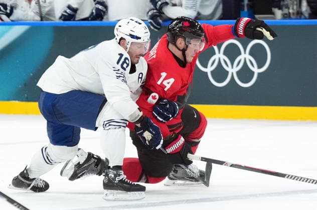 February 15, 2026, Milan, ITALY: Yohann Auvitu (18) of Team France takes down Bo Horvat (14) of Team Canada during second period Olympic hockey action at the 2026 Milan Cortina Winter Olympics in Milan, Italy on Sunday, Feb. 15, 2026. Canada News - February 15, 2026  - ZUMAc35_ 20260215_zaf_c35_093 Copyright: xNathanxDenettex