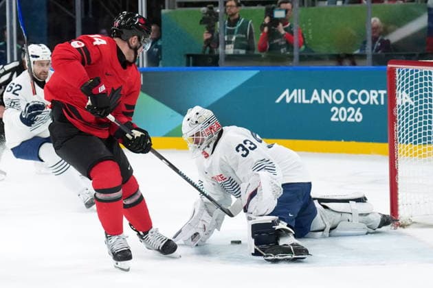 February 15, 2026, Milan, ITALY: Bo Horvat (14) of Team Canada is stopped by Julian Junca (33) of Team France during second period Olympic hockey action at the 2026 Milan Cortina Winter Olympics in Milan, Italy on Sunday, February 15, 2026. Canada News - February 15, 2026  - ZUMAc35_ 20260215_zaf_c35_098 Copyright: xNathanxDenettex