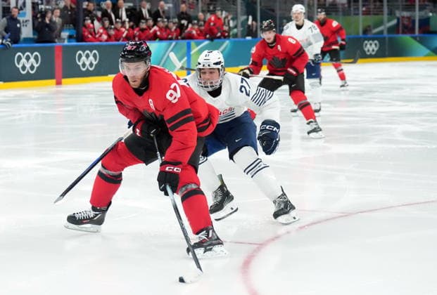 February 15, 2026, Milan, ITALY: Connor McDavid (97) of Team Canada is chased by Jules Boscq (27) of Team France during third period Olympic hockey action at the 2026 Milan Cortina Winter Olympics in Milan, Italy on Sunday, February 15, 2026. Canada News - February 15, 2026  - ZUMAc35_ 20260215_zaf_c35_106 Copyright: xNathanxDenettex