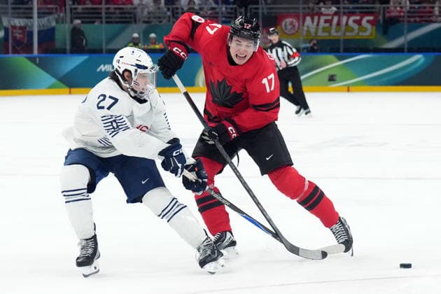 February 15, 2026, Milan, ITALY: Macklin Celebrini (17) of Team Canada and Jules Boscq (27) of Team France battle for the puck during third period Olympic hockey action at the 2026 Milan Cortina Winter Olympics in Milan, Italy on Sunday, February 15, 2026. Canada News - February 15, 2026  - ZUMAc35_ 20260215_zaf_c35_108 Copyright: xNathanxDenettex
