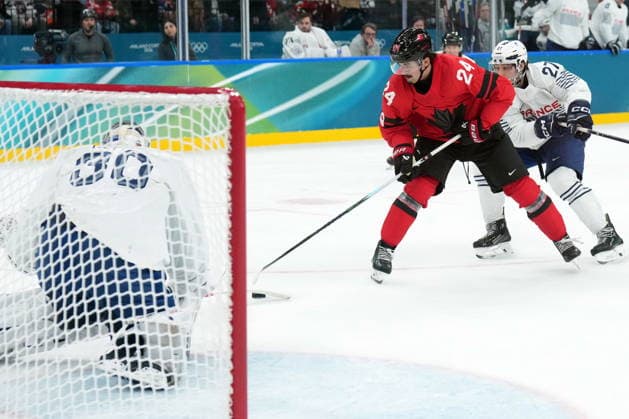 February 15, 2026, Milan, ITALY: Seth Jarvis (24) of Team Canada is stopped by goalie Antoine Keller (30) of Team France as Jules Boscq (27) chases during third period Olympic hockey action at the 2026 Milan Cortina Winter Olympics in Milan, Italy on Sunday, February 15, 2026. Canada News - February 15, 2026  - ZUMAc35_ 20260215_zaf_c35_107 Copyright: xNathanxDenettex