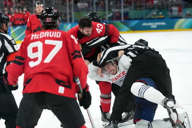 February 15, 2026, Milan, ITALY: Tom Wilson (43) of Team Canada fights with Pierre Crinon (7) of Team France during third period Olympic hockey action at the 2026 Milan Cortina Winter Olympics in Milan, Italy on Sunday, February 15, 2026. Canada News - February 15, 2026  - ZUMAc35_ 20260215_zaf_c35_111 Copyright: xNathanxDenettex