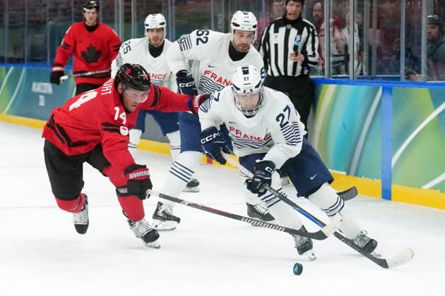 February 15, 2026, Milan, ITALY: Bo Horvat (14) of Team Canada and Jules Boscq (27) of Team France battle for the puck during third period Olympic hockey action at the 2026 Milan Cortina Winter Olympics in Milan, Italy on Sunday, February 15, 2026. Canada News - February 15, 2026  - ZUMAc35_ 20260215_zaf_c35_115 Copyright: xNathanxDenettex