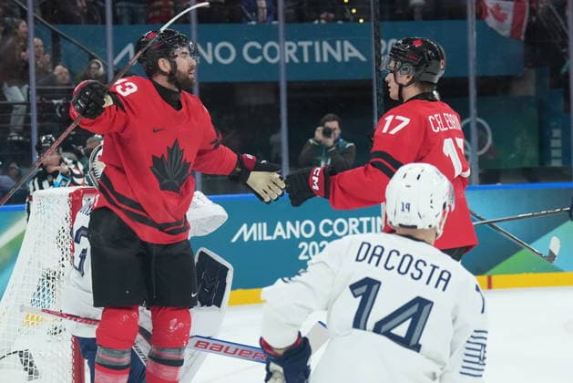 February 15, 2026, Milan, ITALY: Tom Wilson (43) of Team Canada celebrates his goal with teammate Macklin Celebrini (17) as Stephane da Costa (14) of Team France looks on during first period Olympic hockey action at the 2026 Milan Cortina Winter Olympics in Milan, Italy on Sunday Feb. 15, 2026. Canada News - February 15, 2026  - ZUMAc35_ 20260215_zaf_c35_117 Copyright: xNathanxDenettex