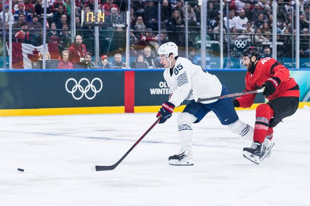 MILANO, ITALY - FEBRUARY 15: Alexandre (France, 85) and Tom Wilson (Canada, 43) battle for the puck during the Ice hockey, Eishockey Men Canada vs France - Preliminary Round - Group A at the Milano Cortina 2026 Olympics at Milano Santagiulia Ice Hockey Arena on day 9 of the Milano Cortina 2026 Olympics on February 15, 2026 in Milano, Italy. Editorial use only. Italy Copyright: xSteffiexWunderlx