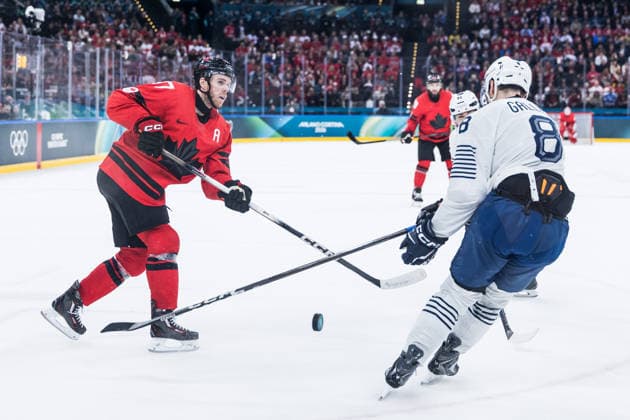 MILANO, ITALY - FEBRUARY 15: Connor McDavid (Canada, 97) controls the puck against Hugo Gallet (France, 8) during the Ice hockey, Eishockey Men Canada vs France - Preliminary Round - Group A at the Milano Cortina 2026 Olympics at Milano Santagiulia Ice Hockey Arena on day 9 of the Milano Cortina 2026 Olympics on February 15, 2026 in Milano, Italy. Editorial use only. Italy Copyright: xSteffiexWunderlx