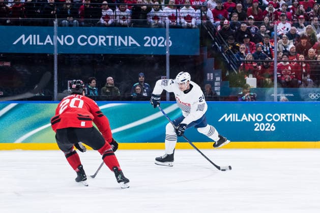 MILANO, ITALY - FEBRUARY 15: Justin Addamo (France, 24) shoots the puck against Thomas Harley (Canada, 20) during the Ice hockey, Eishockey Men Canada vs France - Preliminary Round - Group A at the Milano Cortina 2026 Olympics at Milano Santagiulia Ice Hockey Arena on day 9 of the Milano Cortina 2026 Olympics on February 15, 2026 in Milano, Italy. Editorial use only. Italy Copyright: xSteffiexWunderlx