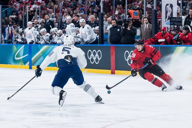 MILANO, ITALY - FEBRUARY 15: Nathan MacKinnon (Canada, 29) controls the puck against Enzo Guebey (France, 5) during the Ice hockey, Eishockey Men Canada vs France - Preliminary Round - Group A at the Milano Cortina 2026 Olympics at Milano Santagiulia Ice Hockey Arena on day 9 of the Milano Cortina 2026 Olympics on February 15, 2026 in Milano, Italy. Editorial use only. Italy Copyright: xSteffiexWunderlx