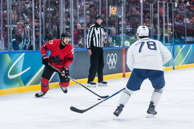 MILANO, ITALY - FEBRUARY 15: Shea Theodore (Canada, 27) controls the puck against Dylan Fabre (France, 78) during the Ice hockey, Eishockey Men Canada vs France - Preliminary Round - Group A at the Milano Cortina 2026 Olympics at Milano Santagiulia Ice Hockey Arena on day 9 of the Milano Cortina 2026 Olympics on February 15, 2026 in Milano, Italy. Editorial use only. Italy Copyright: xSteffiexWunderlx