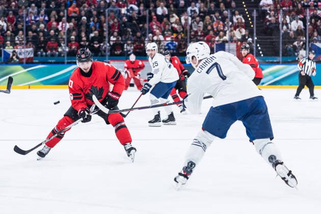 MILANO, ITALY - FEBRUARY 15: Nick Suzuki (Canada, 10) controls the puck during the Ice hockey, Eishockey Men Canada vs France - Preliminary Round - Group A at the Milano Cortina 2026 Olympics at Milano Santagiulia Ice Hockey Arena on day 9 of the Milano Cortina 2026 Olympics on February 15, 2026 in Milano, Italy. Editorial use only. Italy Copyright: xSteffiexWunderlx