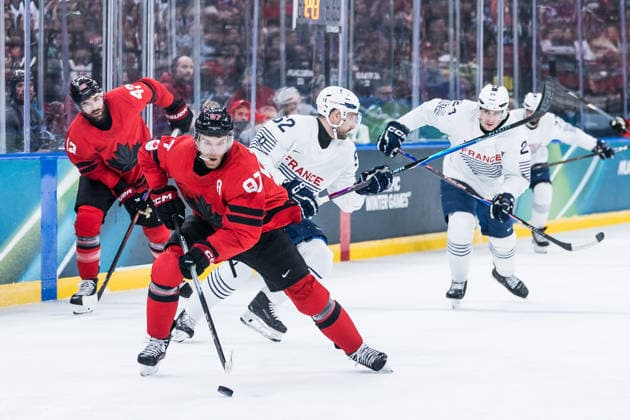 MILANO, ITALY - FEBRUARY 15: Connor McDavid (Canada, 97) controls the puck against Florian Chakiachvili (France, 62) during the Ice hockey, Eishockey Men Canada vs France - Preliminary Round - Group A at the Milano Cortina 2026 Olympics at Milano Santagiulia Ice Hockey Arena on day 9 of the Milano Cortina 2026 Olympics on February 15, 2026 in Milano, Italy. Editorial use only. Italy Copyright: xSteffiexWunderlx