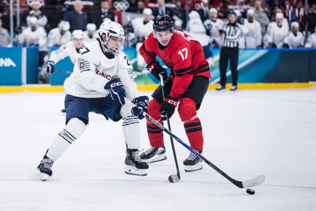 MILANO, ITALY - FEBRUARY 15: Jules Boscq (France, 27) and Macklin Celebrini (Canada, 17) battle for the puck during the Ice hockey, Eishockey Men Canada vs France - Preliminary Round - Group A at the Milano Cortina 2026 Olympics at Milano Santagiulia Ice Hockey Arena on day 9 of the Milano Cortina 2026 Olympics on February 15, 2026 in Milano, Italy. Editorial use only. Italy Copyright: xSteffiexWunderlx