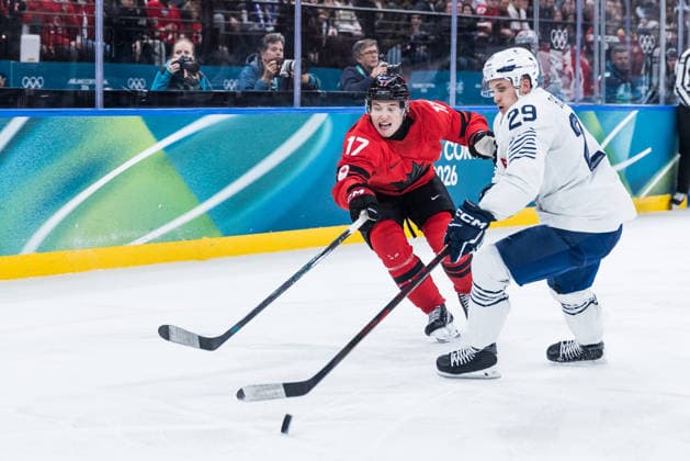MILANO, ITALY - FEBRUARY 15: Macklin Celebrini (Canada, 17) and Louis Boudon (France, 29) fight for the puck during the Ice hockey, Eishockey Men Canada vs France - Preliminary Round - Group A at the Milano Cortina 2026 Olympics at Milano Santagiulia Ice Hockey Arena on day 9 of the Milano Cortina 2026 Olympics on February 15, 2026 in Milano, Italy. Editorial use only. Italy Copyright: xSteffiexWunderlx