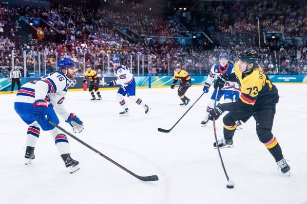 MILANO, ITALY - FEBRUARY 15: Lukas Reichel (Germany, 73) shoots the puck against Noah Hanifin (United States of America, 15) during the Ice hockey, Eishockey Men United States of America vs Germany - Preliminary Round - Group C at the Milano Cortina 2026 Olympics at Milano Santagiulia Ice Hockey Arena on day 9 of the Milano Cortina 2026 Olympics on February 15, 2026 in Milano, Italy. Editorial use only. Italy Copyright: xSteffiexWunderlx