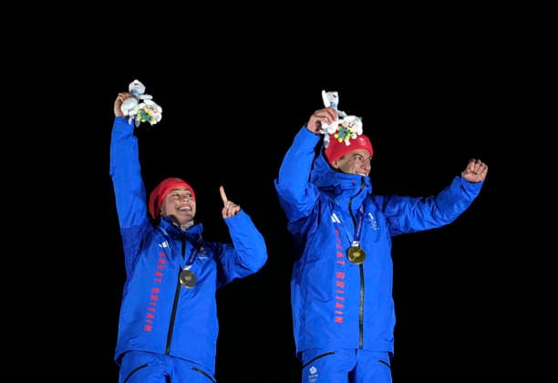 (260215) -- CORTINA D AMPEZZO, Feb. 15, 2026 -- Gold medalists Tabitha Stoecker (L) Matt Weston of Britain celebrate during the awarding ceremony of the skeleton mixed team competition at the Milan-Cortina 2026 Olympic Winter games, Winterspiele,Spiele, Summer games in Cortina, Italy, Feb. 15, 2026. ) (MICO2026)ITALY-CORTINA D AMPEZZO-OLYMPIC WINTER GAMES-SKELETON MIXED TEAM LixGang 