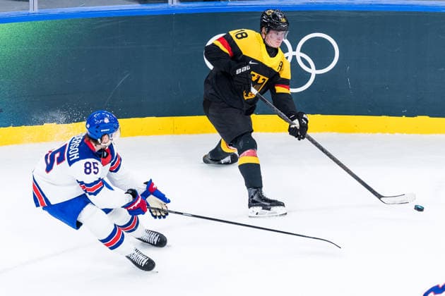 MILANO, ITALY - FEBRUARY 15: Tim Stuetzle (Germany, 18) controls the puck against Jake Sanderson (United States of America, 85) during the Ice hockey, Eishockey Men United States of America vs Germany - Preliminary Round - Group C at the Milano Cortina 2026 Olympics at Milano Santagiulia Ice Hockey Arena on day 9 of the Milano Cortina 2026 Olympics on February 15, 2026 in Milano, Italy. Editorial use only. Italy Copyright: xSteffiexWunderlx