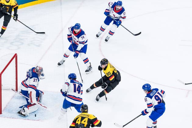 MILANO, ITALY - FEBRUARY 15: Connor Hellebuyck (United States of America, 37) defends against a shot by Frederik Tiffels (Germany, 95) during the Ice hockey, Eishockey Men United States of America vs Germany - Preliminary Round - Group C at the Milano Cortina 2026 Olympics at Milano Santagiulia Ice Hockey Arena on day 9 of the Milano Cortina 2026 Olympics on February 15, 2026 in Milano, Italy. Editorial use only. Italy Copyright: xSteffiexWunderlx