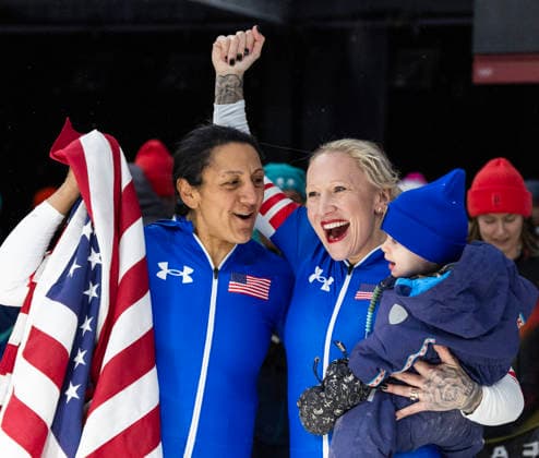 February 16, 2026, Cortina D ampezzo, Lombardy, Italy: Golf medal winner Elana Meyers Taylor of the USA, left, with teammate and bronze medal winner Kaillie Armbruster Humphries after the Women s Monobob at the Cortina Sliding Centre for the Milano Cortina 2026 Winter Olympics. Armbruster Humphries is holding her son Aulden. Cortina D ampezzo Italy - ZUMAsc5_ 20260216_oly_sc5_006 Copyright: xErichxSchlegelx