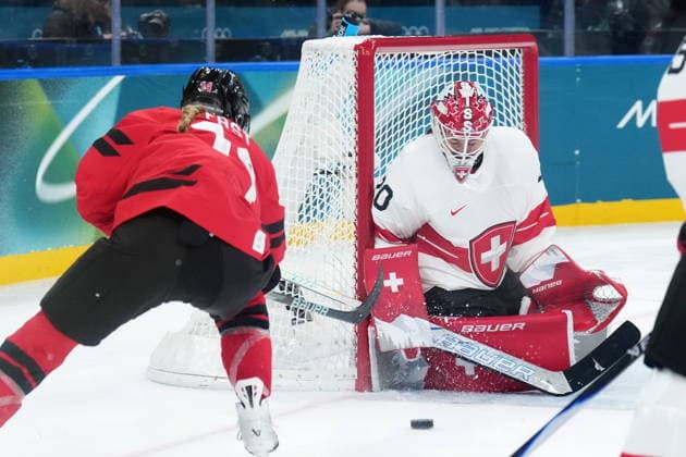 February 16, 2026, Milan, ITALY: Canada s Renata Fast (14) gets stopped by Switzerland s Andrea Braendli (20) during first period women s Olympic semifinal hockey action at the 2026 Milan Cortina Winter Olympics in Milan, Monday, Feb. 16, 2026. Canada News - February 16, 2026  - ZUMAc35_ 20260216_zaf_c35_178 Copyright: xNathanxDenettex