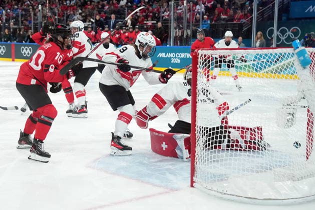 February 16, 2026, Milan, ITALY: Canada s Sarah Fillier (10) looks on as a shot from teammate Marie-Philip Poulin (29) gets past Switzerland s Andrea Braendli (20) during second period women s Olympic semifinal hockey action at the 2026 Milan Cortina Winter Olympics in Milan, Monday, Feb. 16, 2026. Canada News - February 16, 2026  - ZUMAc35_ 20260216_zaf_c35_186 Copyright: xNathanxDenettex