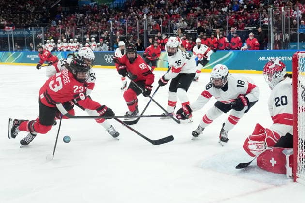 February 16, 2026, Milan, ITALY: Switzerland s Andrea Braendli (20) stops Canada s Erin Ambrose (23) as Switzerland s Vanessa Schaefer (53) ties her up during second period women s Olympic semifinal hockey action at the 2026 Milan Cortina Winter Olympics in Milan, Monday, Feb. 16, 2026. Canada News - February 16, 2026  - ZUMAc35_ 20260216_zaf_c35_188 Copyright: xNathanxDenettex