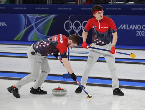 USA s Ben Richardson (L) and Aidan Oldenburg polish the ice in their match against China in the Round Robin Team Curling match at the 2026 Winter Olympics in Cortina, Italy on Tuesday February 17, 2026. China won the match 8-5.  OLY20260217606 HUGOxPHILPOTT