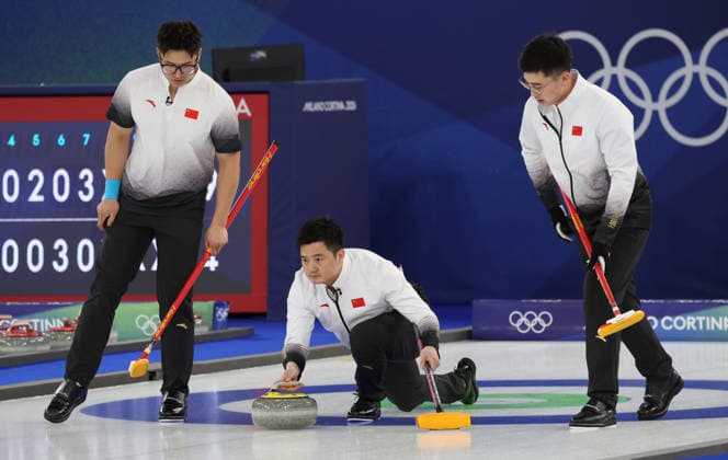 China s Xu Xiaoming (C) releases the stone in their match against USA in the Round Robin Team Curling match at the 2026 Winter Olympics in Cortina, Italy on Tuesday February 17, 2026. China won the match 8-5.  OLY20260217611 HUGOxPHILPOTT