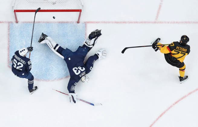 (260217) -- MILAN, Feb. 17, 2026 -- John Peterka (R) of Germany scores during the Ice hockey, Eishockey men s qualification play-off match between Germany and France at the Milan-Cortina 2026 Olympic Winter games, Winterspiele,Spiele, Summer games in Milan, Italy, Feb. 17, 2026. ) (MICO2026)ITALY-MILAN-OLYMPIC WINTER GAMES-ICE HOCKEY-MEN-QUALIFICATION PLAY-OFF-GER VS FRA WangxKaiyan 