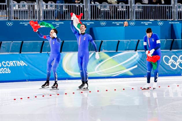 Davide Ghiotto of Italy and Michele Malfatti of Italy and Andrea Giovannini of Italy celebrating and holding flag after Men s Team Pursuit Finals, Milano Cortina 2026 Winter Olympics: Day 11, Speed skating, Eisschnelllauf - Milano Cortina 2026 Winter Olympics: Day 11, Milano Speed Skating Stadium, February 17, 2026, Milan, Italy.