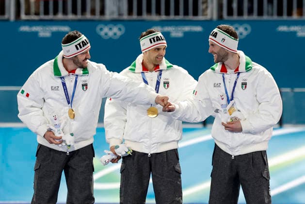 Davide Ghiotto of Team Italy fist-bumps Michele Malfatti after receiving their gold medals during the medal ceremony after the Men s Speed skating, Eisschnelllauf Team Pursuit Finals at the Milano Speed Skating Stadium in Milan, Italy on Tuesday, February 17, 2026. The United States won silver and China won bronze.  OLY20260217963 AARONxJOSEFCZYK