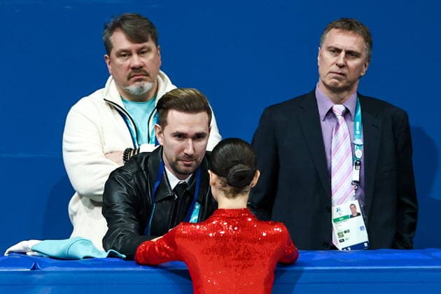 ITALY, MILAN - FEBRUARY 17, 2026: AIN athlete Adeliia Petrosian from Russia (C front) and Russian coach Daniil Gleikhengauz (L midground) during the women s singles short programme at the 2026 Winter Olympic Games, Olympische Spiele, Olympia, OS at Milano Ice Skating Arena. Mikhail Tereshchenko TASS  88859396