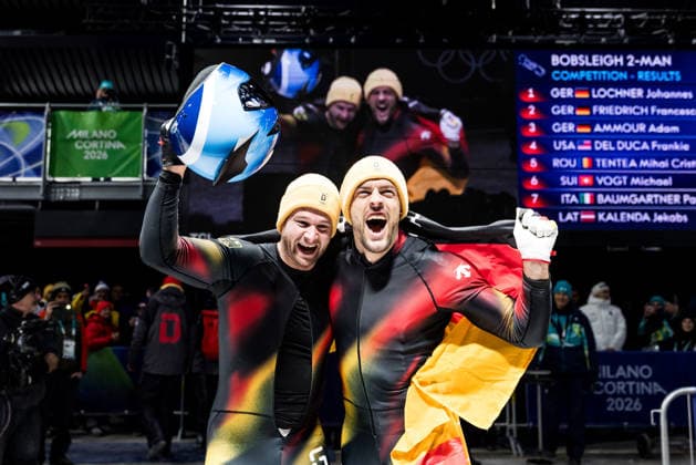 CORTINA, ITALY - FEBRUARY 17: Johannes Lochner and Georg Fleischhauer (Germany) cheer after winning Gold during the Bobsleigh 2-man at the Milano Cortina 2026 Olympics at Cortina Sliding Centre on day 11 of the Milano Cortina 2026 Olympics on February 17, 2026 in Cortina, Italy. Editorial use only. Italy Copyright: xSteffiexWunderlx