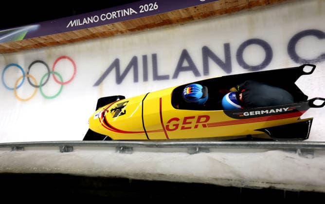 (260218) -- CORTINA D AMPEZZO, Feb. 18, 2026 -- Adam Ammour (L) Alexander Schaller of Germany compete during the Bobsleigh 2-man heat 3 at the Milan-Cortina 2026 Olympic Winter games, Winterspiele,Spiele, Summer games in Cortina D Ampezzo, Italy, Feb. 17, 2026. ) (MICO2026)ITALY-CORTINA D AMPEZZO-OLYMPIC WINTER GAMES-BOBSLEIGH-2-MAN DingxXu 
