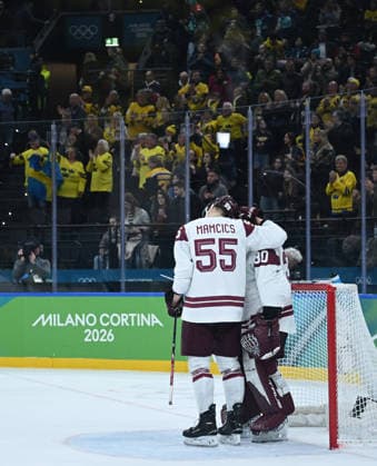 (260218) -- MILAN, Feb. 18, 2026 -- Roberts Mamcics (L) and Elvis Merzlikins of Latvia react after the Ice hockey, Eishockey men s qualification play-off match between the Sweden and Latvia at the Milan-Cortina 2026 Olympic Winter games, Winterspiele,Spiele, Summer games in Milan, Italy, Feb. 17, 2026. ) (MICO2026)ITALY-MILAN-OLYMPIC WINTER GAMES-ICE HOCKEY-MEN-QUALIFICATION PLAY-OFF-SWE VS LAT ZhangxHaofu 